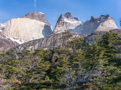 The mountains in the National Park of Torres del Paine have some interesting shapes. Glacial erosion is mainly responsible for the sculpturing of the massif in the last tens of thousands of years. A fine example are los Cuernos whose central bands of exposed granite contrast strongly with the dark aspect of their peaks.